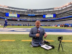 Dave Stevens reporting on a football field.